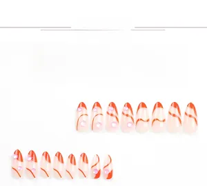 Detail view of orange French press-on nails with mermaid pearls and short almond shape