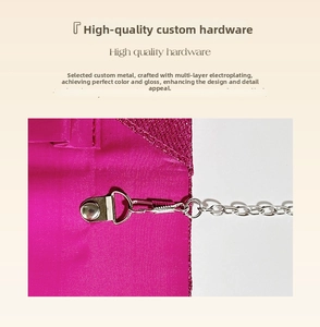 Detail of rose red glitter evening bag with silver lobster clasp and metal chain strap