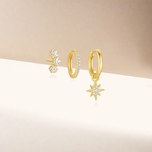 Three-piece set of gold S925 silver earrings featuring star charms and zircon crystals