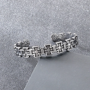 Detail view of vintage stainless steel cuff bracelet with engraved Iron Cross patterns