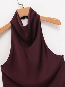Detail view of burgundy satin halter top showing its smooth texture and elegant drape