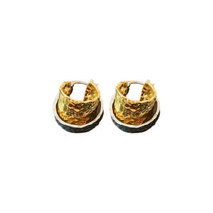 Textured gold and silver two-tone oval heart hoop earrings on a clean white background