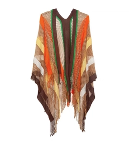 Close-up of knit shawl fringe and colorful rainbow striped pattern on soft fabric
