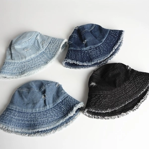 Distressed denim bucket hats with frayed edges in light blue, dark blue and black colors