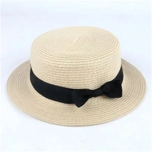 Women boater straw hat with black ribbon bow for sun protection and beach travel
