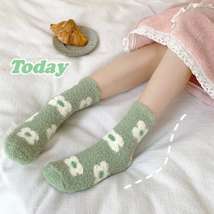 Fuzzy coral fleece mid-calf socks with white flower pattern in grass green color
