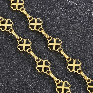 Macro detail of gold-plated hollow four-leaf clover chain with high metallic luster finish