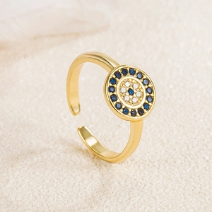 Macro shot of gold evil eye silver ring with blue and clear zircon stones details