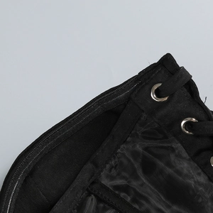 Detail of corset side zipper with metal eyelets and black lace-up tie on smooth fabric
