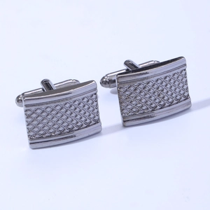 Detail of gunmetal square cufflinks featuring a classic engraved grid pattern for men