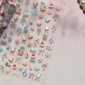 Detailed close-up of 5D embossed nail stickers with summer beach and seashell motifs