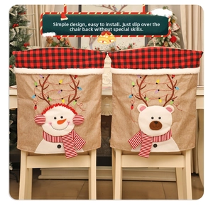 Detail of burlap Christmas chair covers with plaid trim and cute snowman bear designs