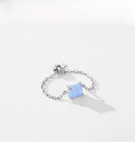 Detailed shot of an adjustable S925 silver chain ring with a square blue opal stone