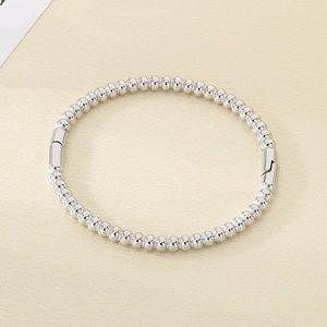 Detailed view of polished stainless steel beads on a minimalist silver sphere bracelet