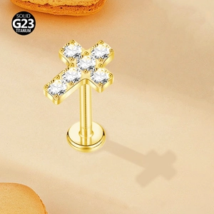 Detail view of G23 titanium gold cross labret stud with sparkling crystal zircons