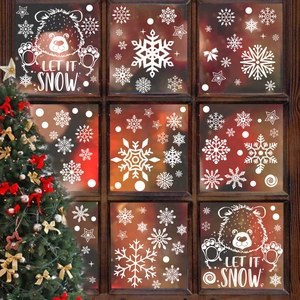 Christmas window stickers featuring white polar bears, snowflakes and stars on a glass window