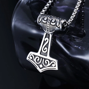Macro shot of Viking Mjolnir pendant showing intricate carvings and S.Steel engraving