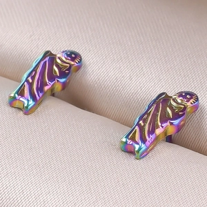 Macro shot of colorful iridescent 304 stainless steel earrings with holy figure design