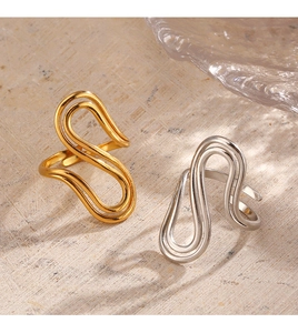 Macro detail of wave shaped adjustable stainless steel rings in gold and silver finish