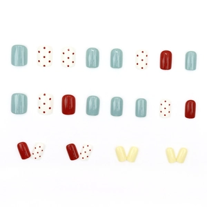 Short square press-on nails with red polka dots and matte blue minimalist chic design
