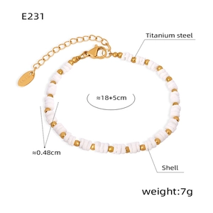 Detail of beaded bracelet featuring white shell discs, gold titanium steel beads and clasp