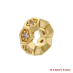 Macro detail of hexagonal gold honeycomb bead with cubic zirconia inlay 4.0x8.5mm