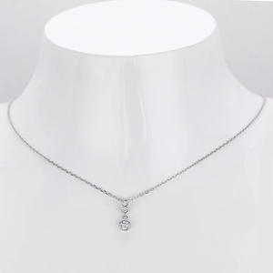 Minimalist S925 silver necklace featuring three graduated round stones on white neck bust