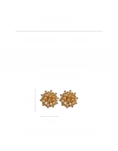 Detailed view of flower-shaped gold-plated copper earrings with cubic zirconia and silver pin