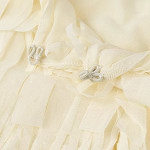 Beige tassel layered blouse with round neck long sleeves and silver metal buckles