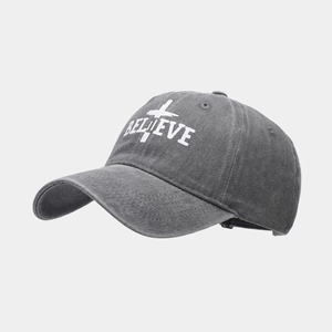 Washed dark gray baseball cap with BELIEVE print and vintage distressed finish