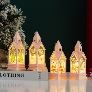 Close-up of four pink mini Christmas lanterns with LED lights and holiday illustrations