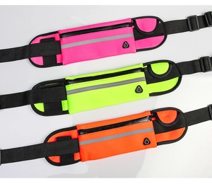 Detail of running belts in pink, yellow and orange with reflective strips and waterproof zips