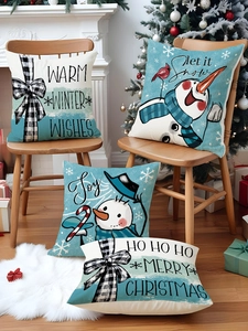 Detailed texture of festive linen pillowcases with snowman and red bird holiday prints