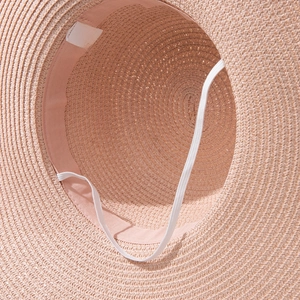 Close-up of the 100% paper straw hat interior with sweatband and windproof strap