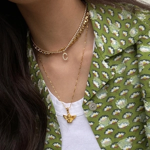 Gold layered necklace set featuring a crystal C letter charm and angel coin pendant