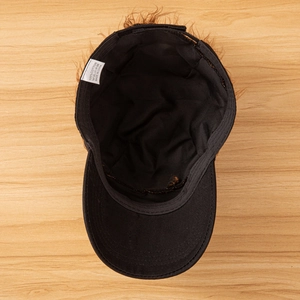 Detail view of cotton lining and washing label inside the black wig baseball cap