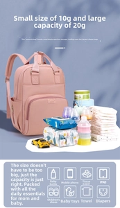 Pink diaper backpack detail showing organized storage for baby bottles and essentials