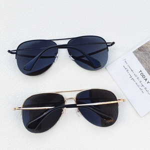 Classic aviator sunglasses in black and gold metal frames with dark grey lenses