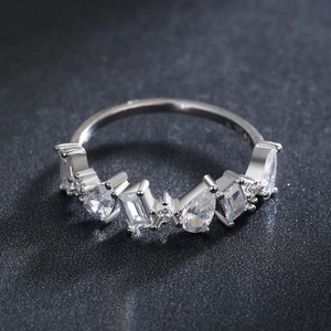 Irregular zircon S925 silver ring featuring pear and emerald cut stones on black background