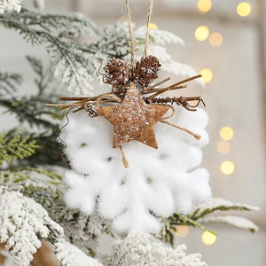 White snowflake Christmas ornament with pine cones and wooden star on rustic jute string