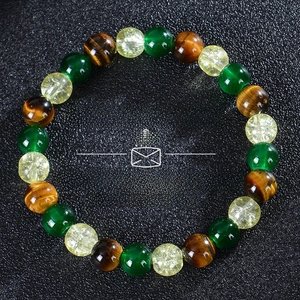 Detail of beaded money success bracelet with tiger eye, citrine and malachite beads