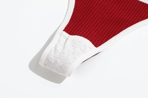 Close-up of red ribbed cotton thong showing precise stitching and soft inner lining texture