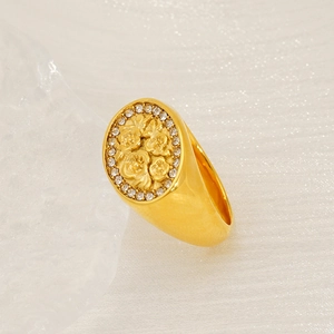 Vintage gold oval signet ring with embossed floral pattern and crystal pavé setting