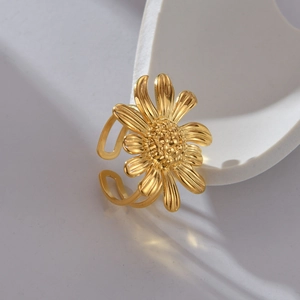Macro detail of golden sunflower open ring showcasing textured petals and polished finish