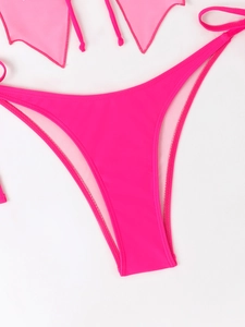 Detail of hot pink bikini bottoms with high cut design and side straps on white background