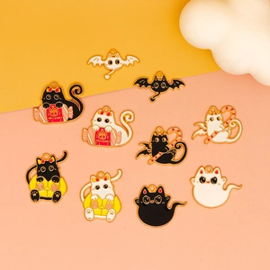 Detailed view of Halloween cat alloy charms in black and white styles on orange backdrop