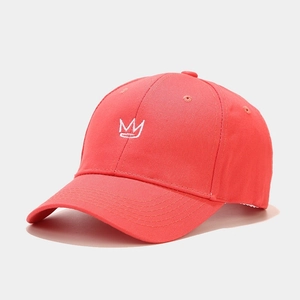 Close-up of crown embroidery on coral cotton baseball cap with premium stitching detail