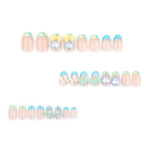 Blue and white French tip press-on nails with 3D stars and ribbon bow accents