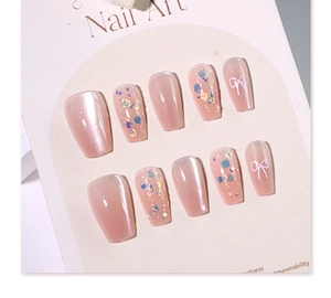 Detailed view of nude cat eye press-on nails with white butterfly and glitter gradient