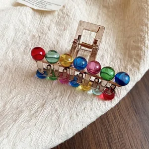 Colorful acrylic hair claw clip with vibrant candy-colored beads on a clear brown base